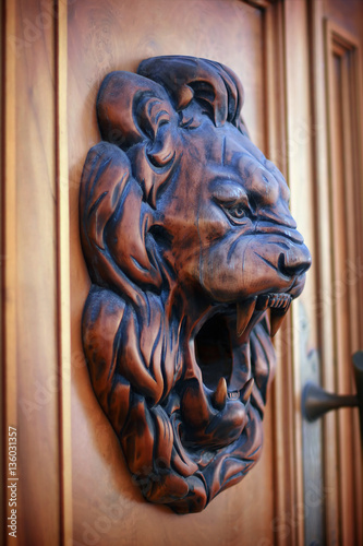 Fotografering Wooden relief of lion
