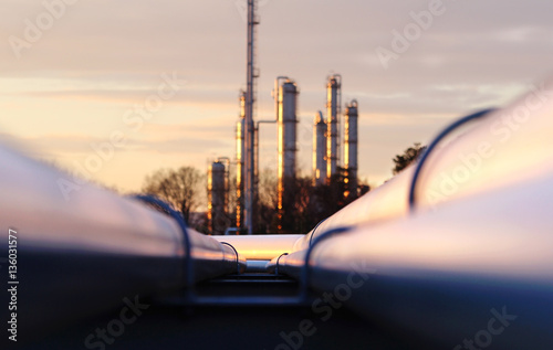 sunset at crude oil refinery with pipeline network photo