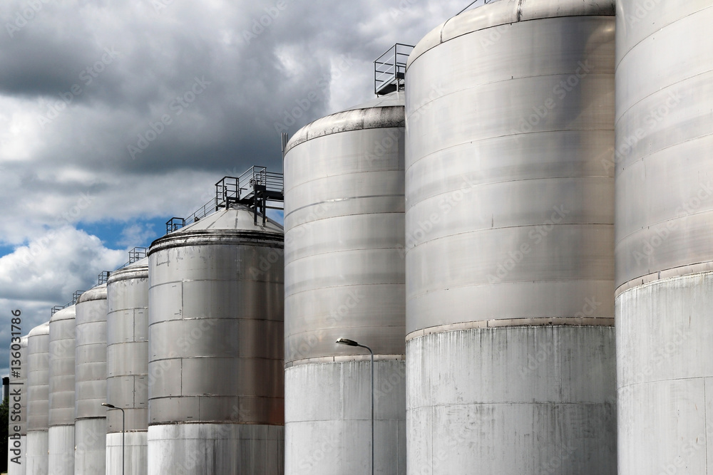 large stainless steel fermentation vessel under cloudy sky large stainless steel fermentation vessel under cloudy sky