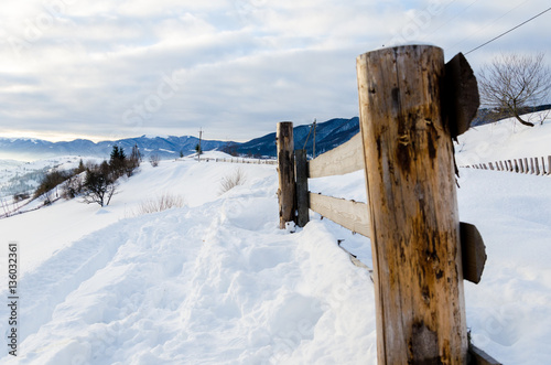 Wooden fences foreground. Winter mountain view at dawn, the sun' © Svfotoroom