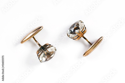 Ancient gold men's cuff links with rock crystal are isolated on a white background
