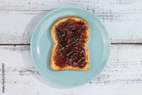 Typical Dutch apple syrup called Appelstroop on bread on wooden background