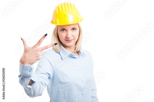 Female architect showing number three gesture