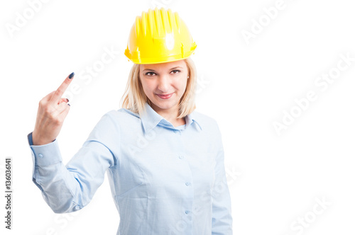 Female engineer wearing helmet showing obscene gesture