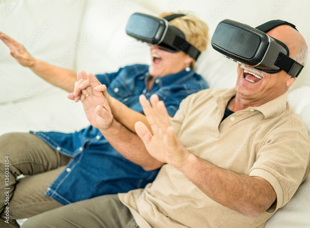 Fototapeta premium Senior mature couple having fun with virtual reality glasses