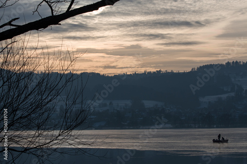 Sunset over a fozen lake in winter photo
