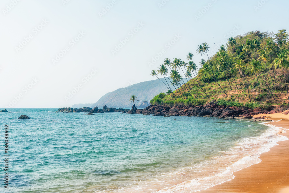 Ocean Beach in summer sunlight. Goa, India. Vivid, splittoned image. 