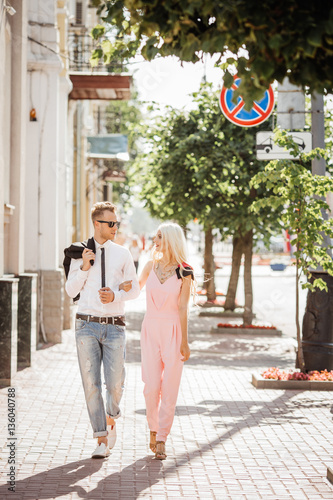 portrait of a beautiful couple walking in the street in summer © kaninstudio