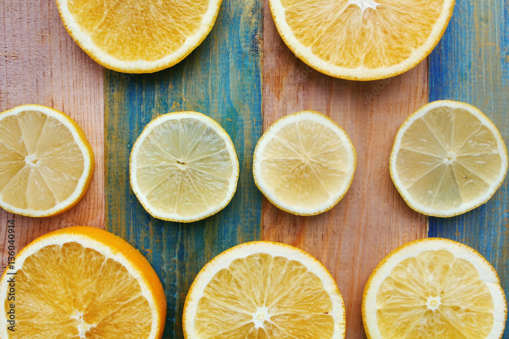 slices of lemon and orange on a wooden table slices of lemon and orange on a wooden table