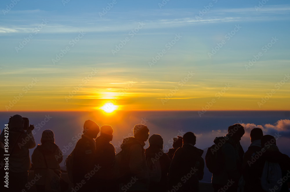 Sunrise at the skyline and silhouette people