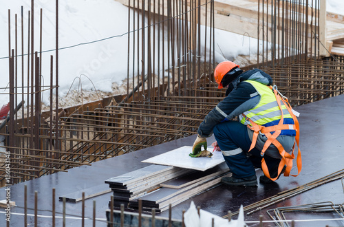 Consulting engineers working with hard hat and holding blueprint