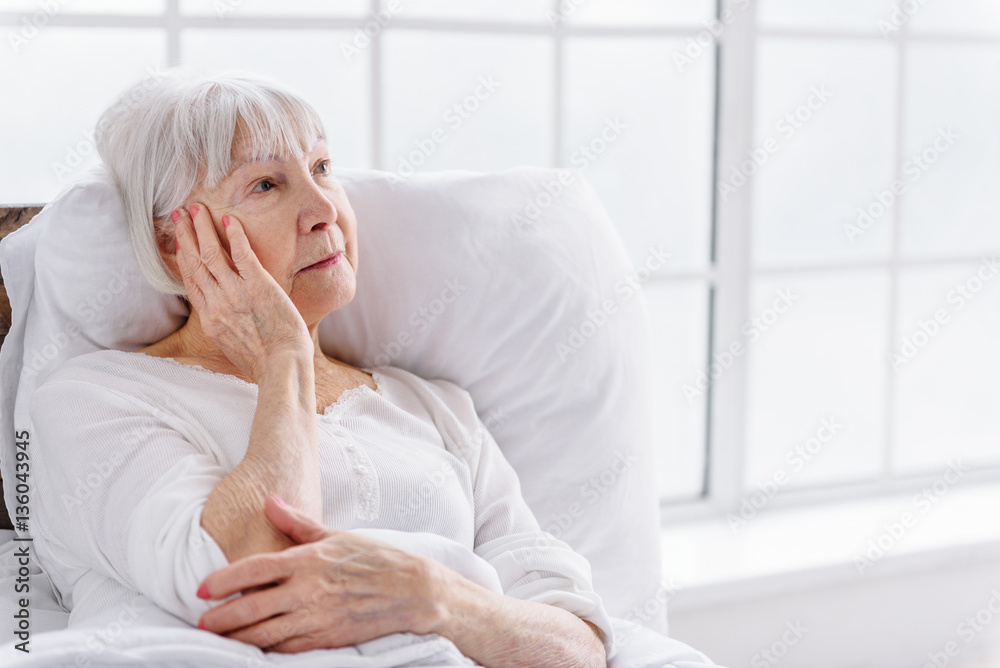 Worried patient reclining in cot at clinic Worried patient reclining in cot at clinic