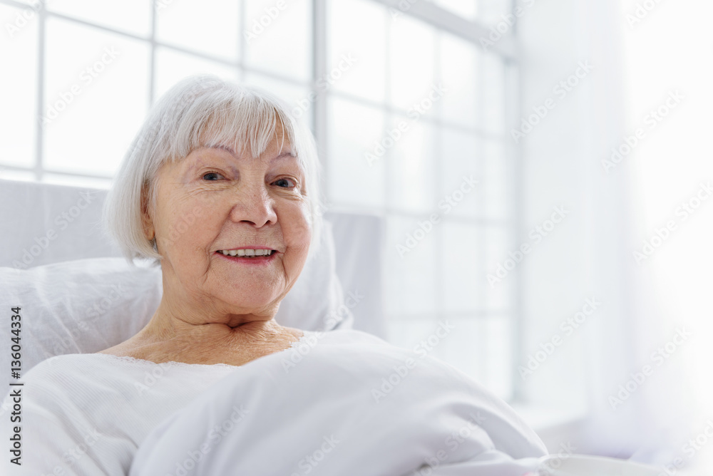 Outgoing pensioner reclining in comfortable cot
