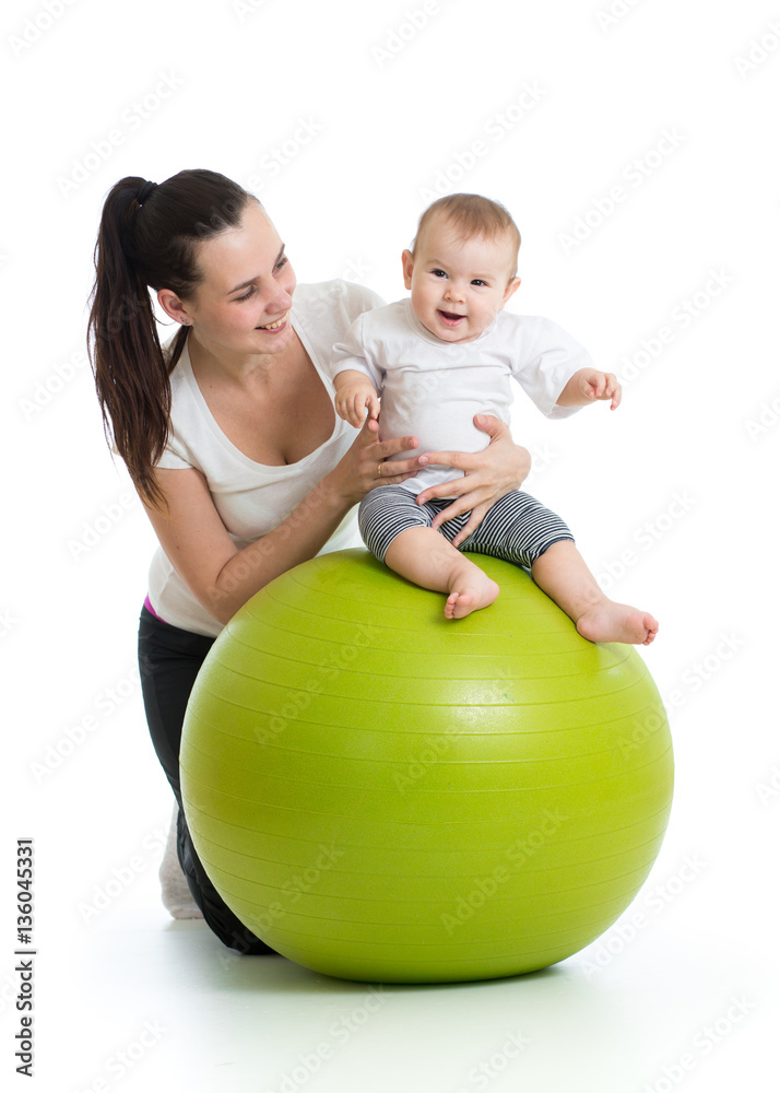 young mother and her baby infant doing yoga exercises on gymnastic ball isolated over white young mother and her baby infant doing yoga exercises on gymnastic ball isolated over white