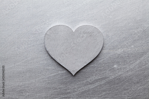 Silver heart on scratched metal  background