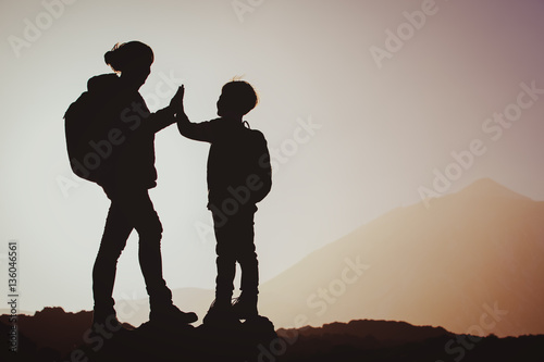 happy mother and little son travel at sunset
