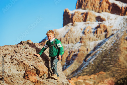 little boy hiking climb in mountains