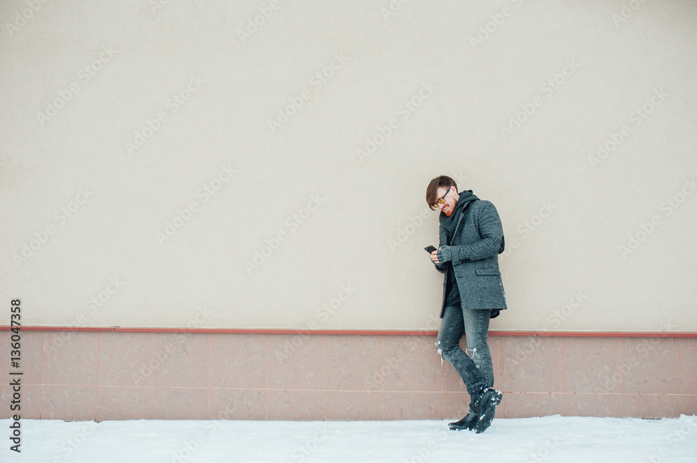 Stylish bearded man calling on the phone in the winter Stylish bearded man calling on the phone in the winter