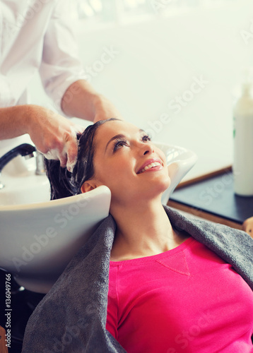 happy young woman at hair salon