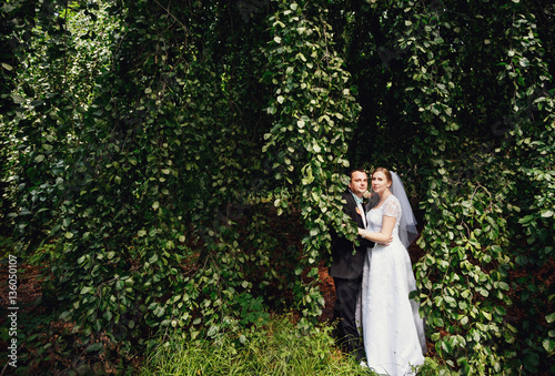 The lovely brides embracing in park