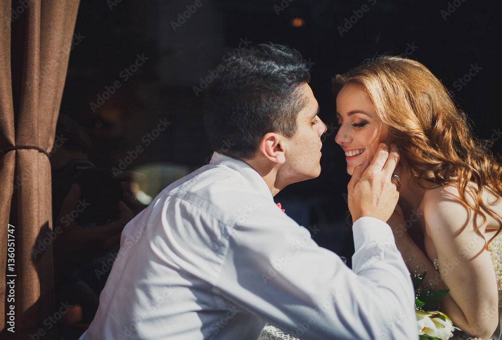 The lovely couple in love sits in restaurant The lovely couple in love sits in restaurant