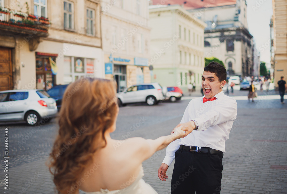 The lovely couple in love dancing on the square The lovely couple in love dancing on the square