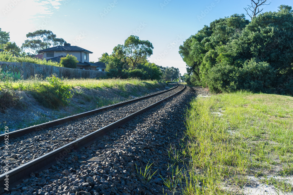 Fototapeta premium Rail tracks winding into the distance in rural area.