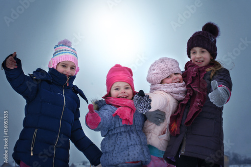 Four girls posing in the snow.