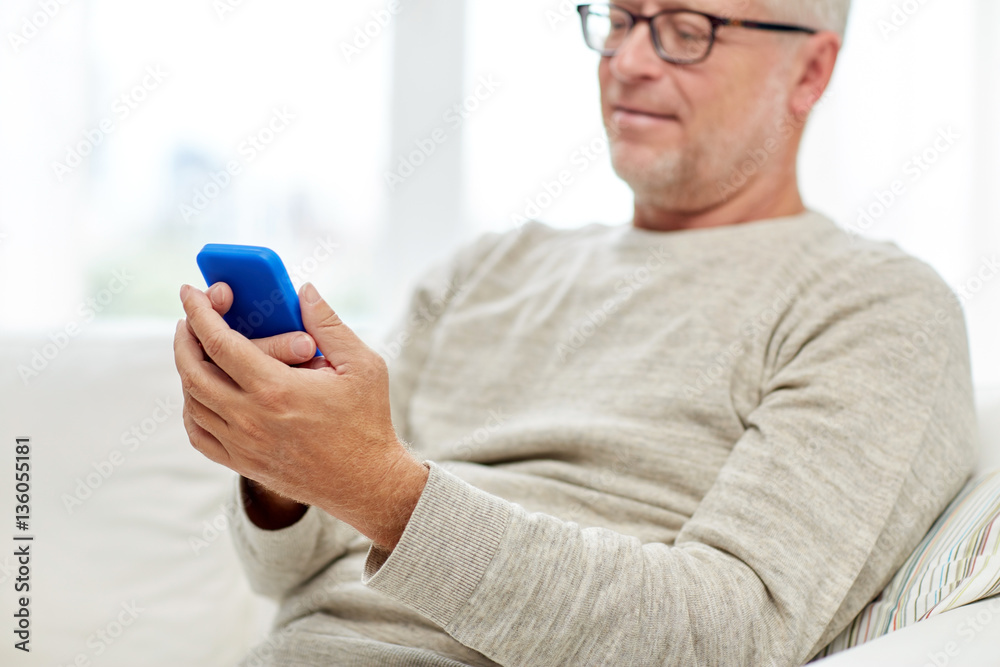 close up of senior man with smartphone at home close up of senior man with smartphone at home