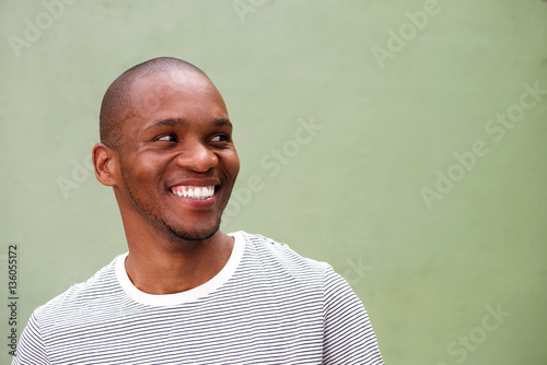 confident young black man looking sideways and smiling photo