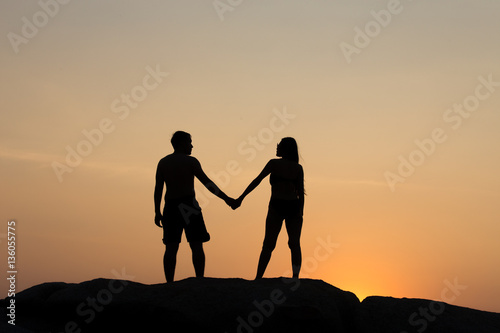 silhouette of couple at sunset summer, healthy concept.