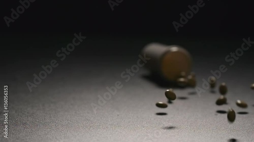 SLOW MOTION: Plastic bottle with a pills fall on a floor