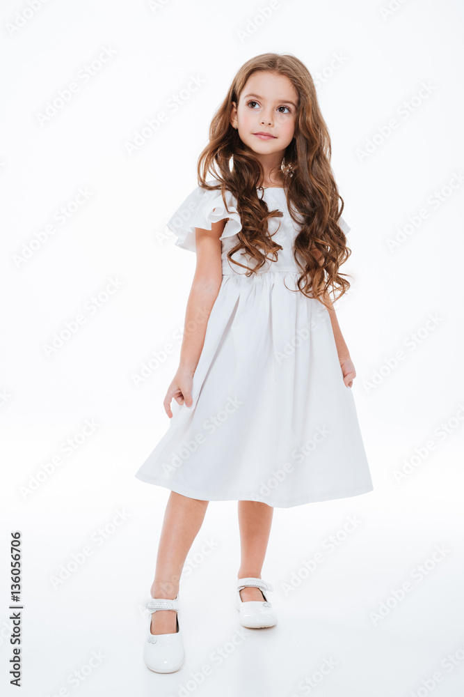 Full length of little girl in dress standing and posing Full length of little girl in dress standing and posing