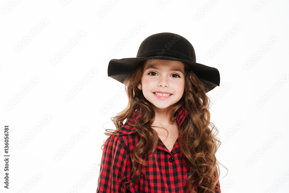 Portrait of happy little girl in plaid shirt and hat Portrait of happy little girl in plaid shirt and hat