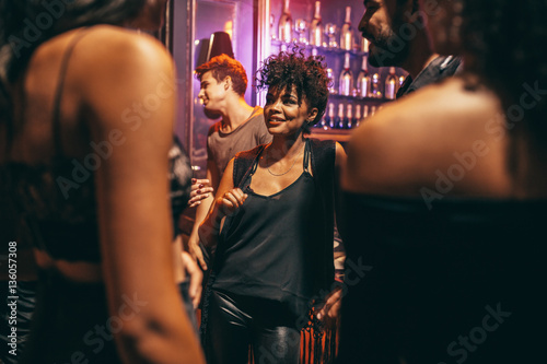 Young woman with her friends at nightclub