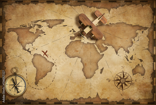 Small wood airplane over world nautical map as travel and communication concept