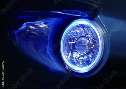 Lit blue colored headlight with reflections