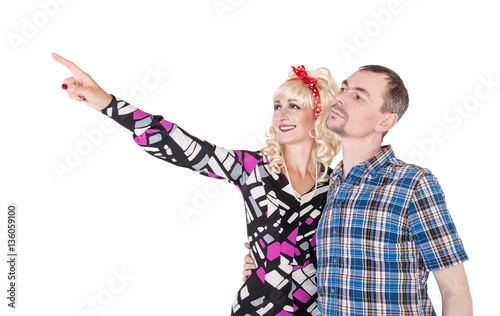 Funny retro family couple embracing and pointing up isolated photo