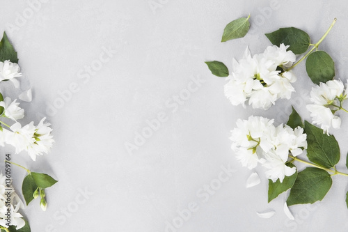 Mock orange branches on grey background from above.
