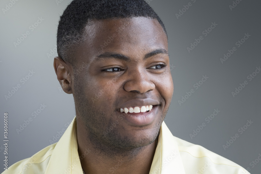 Portrait of a young black man, smiling, looking away Portrait of a young black man, smiling, looking away