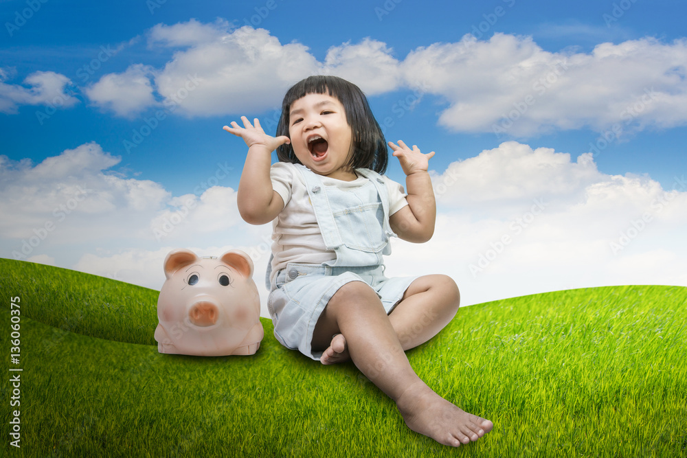 conceptual image, happy child little girl sitting close a piggy conceptual image, happy child little girl sitting close a piggy