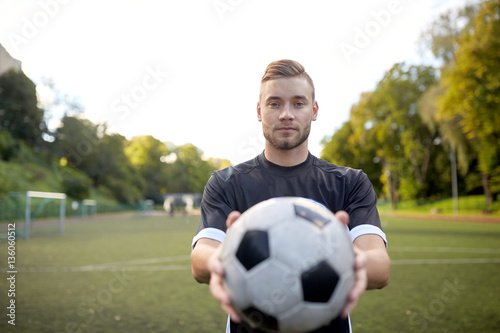 soccer player with ball on football field © Syda Productions