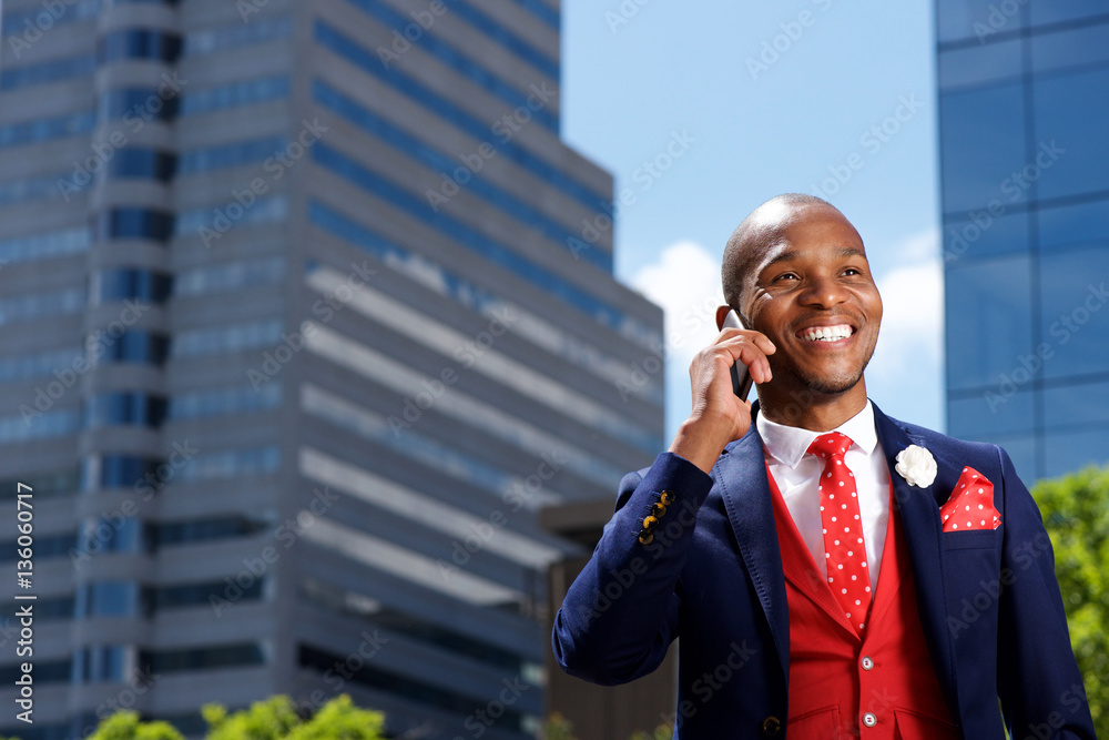 young businessman outside in city and talking on mobile phone young businessman outside in city and talking on mobile phone