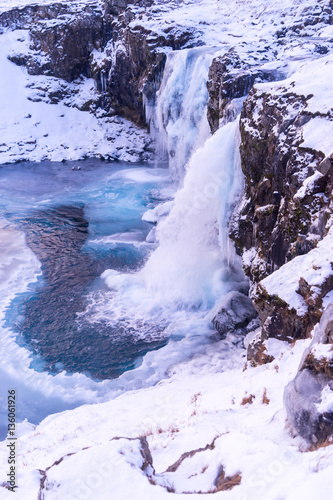 The frozen Kirkjufell waterfall in winter. Iceland