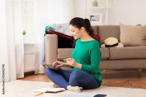 woman with tablet pc and credit card at home