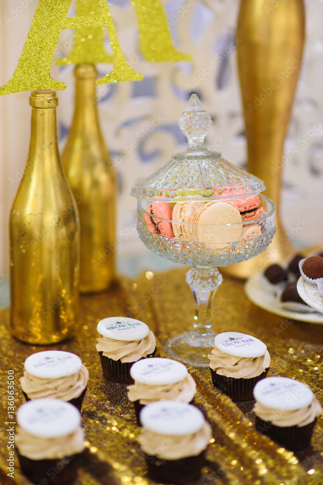golden candy bar with macaron