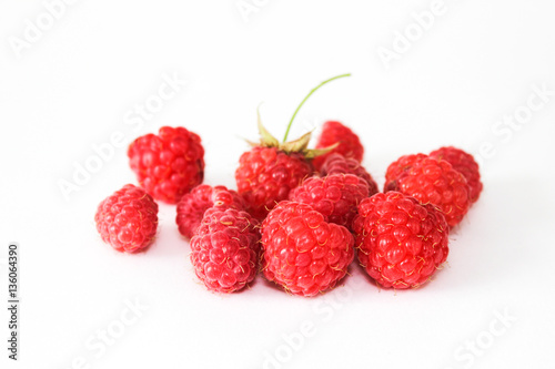 Heap of red ripe raspberry isolated on white