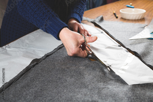 Seamstress hands cutting fabric