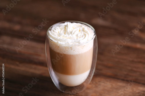 Cup of fresh coffee on wooden background