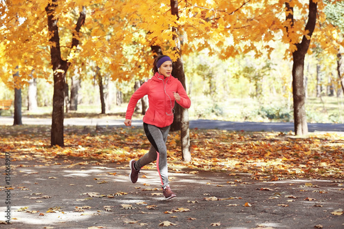 Sporty young woman running ...